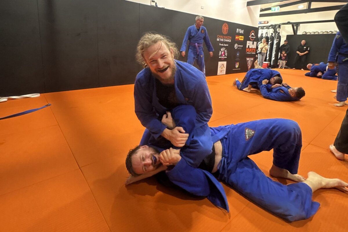 Two members laughing while rolling in Brazilian Jiu Jitsu at Chau Kaizen in Prospect