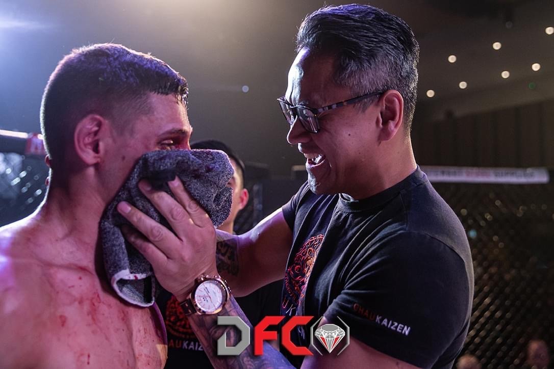 Suasday Chau in the corner with a Chau Kaizen fighter after a bout at a DFC mixed martial arts event