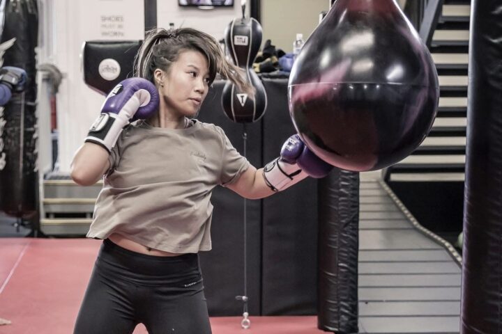 Member throwing an uppercut into an aqua bag during a fitness kickboxing class at Chau Kaizen