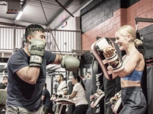 Fitness kickboxing class practising pad work at Chau Kaizen in Prospect, Adelaide