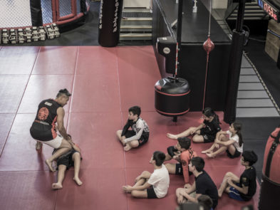 Kids MMA class training with a coach on the mats at Chau Kaizen in Prospect, Adelaide